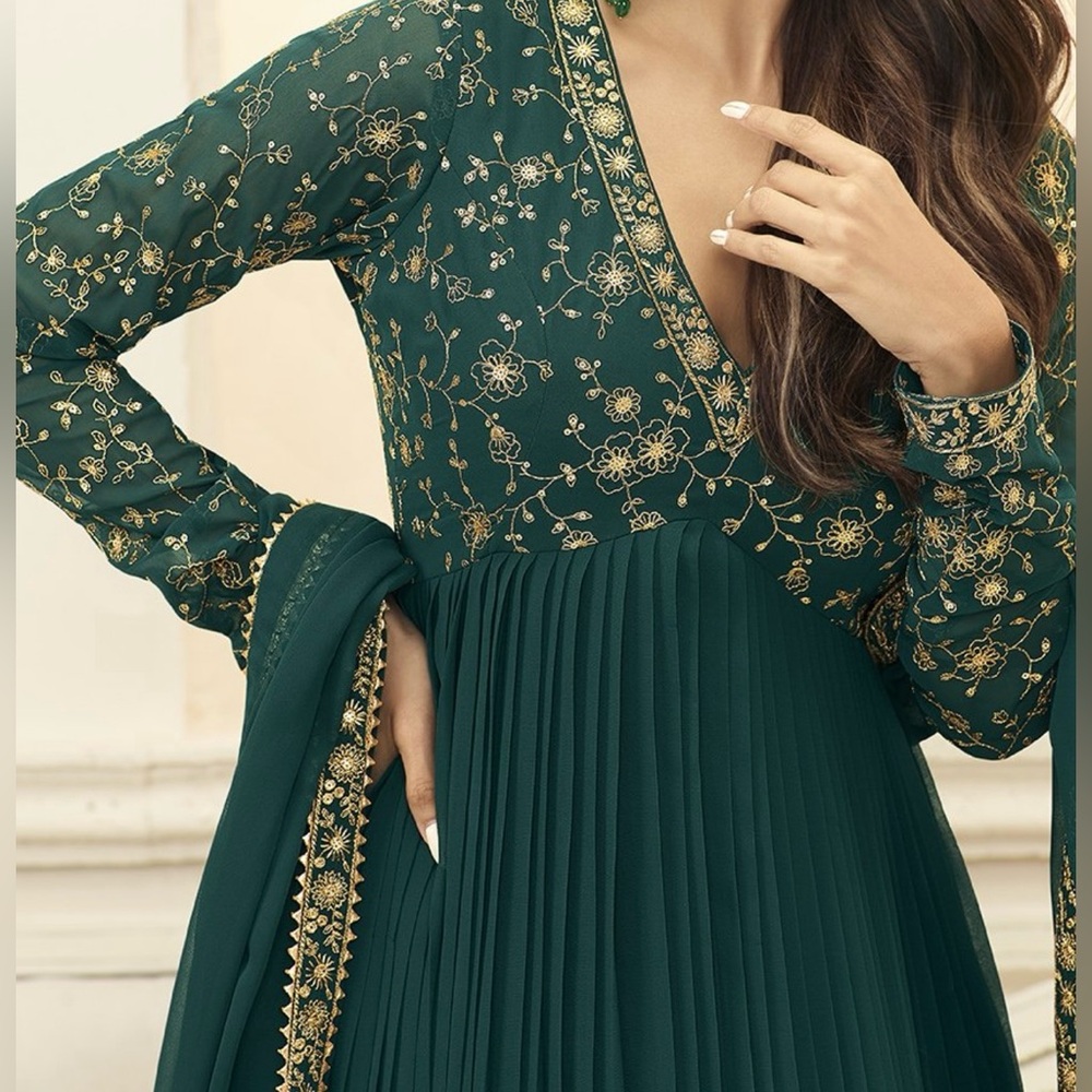 Green anarkali dress with golden thread work.